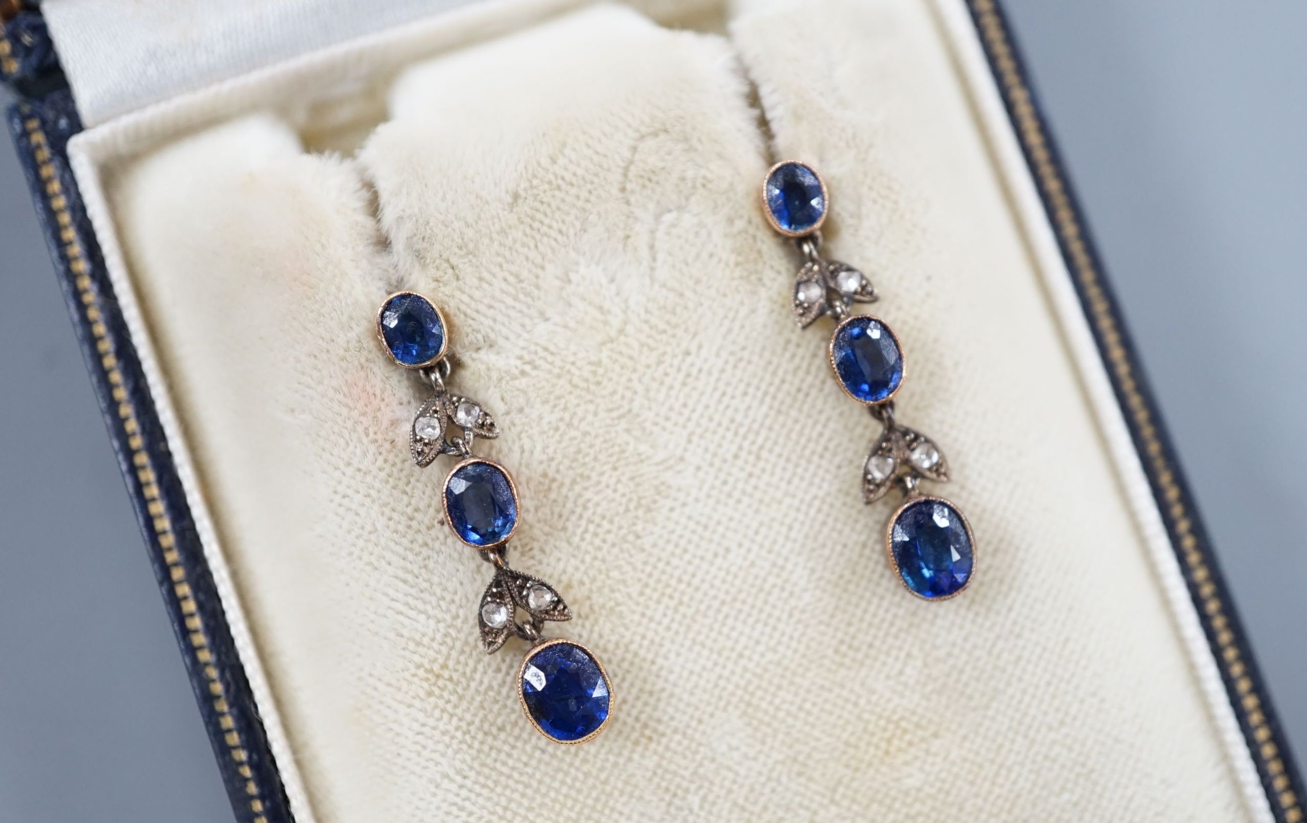 A pair of late Victorian 9ct, three stone sapphire and four stone rose cut diamond set drop earrings, 25mm, gross 3.1 grams.